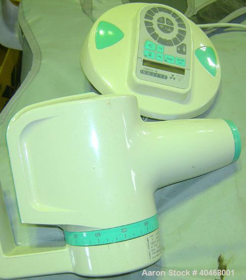 Used ADEC dental chair (gray) with unattached tray, ADEC light, and unattached Elitys X-ray machine with control panel.