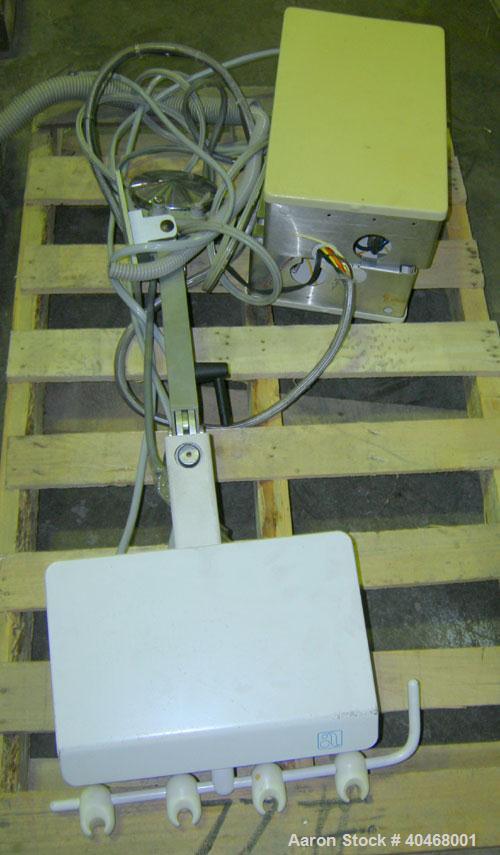Used ADEC dental chair (gray) with unattached tray, ADEC light, and unattached Elitys X-ray machine with control panel.