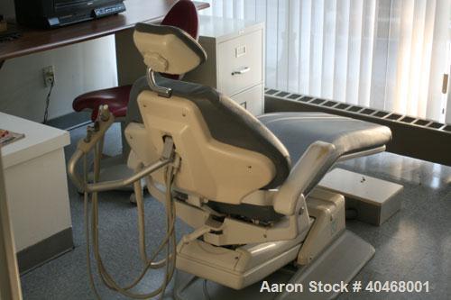 Used ADEC dental chair (gray) with unattached tray, ADEC light, and unattached Elitys X-ray machine with control panel.