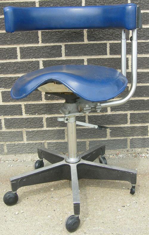 Used Dentsply blue assistant stool.  Mounted on casters.
