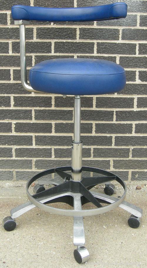 Used Dentsply blue assistant stool.  Mounted on casters.
