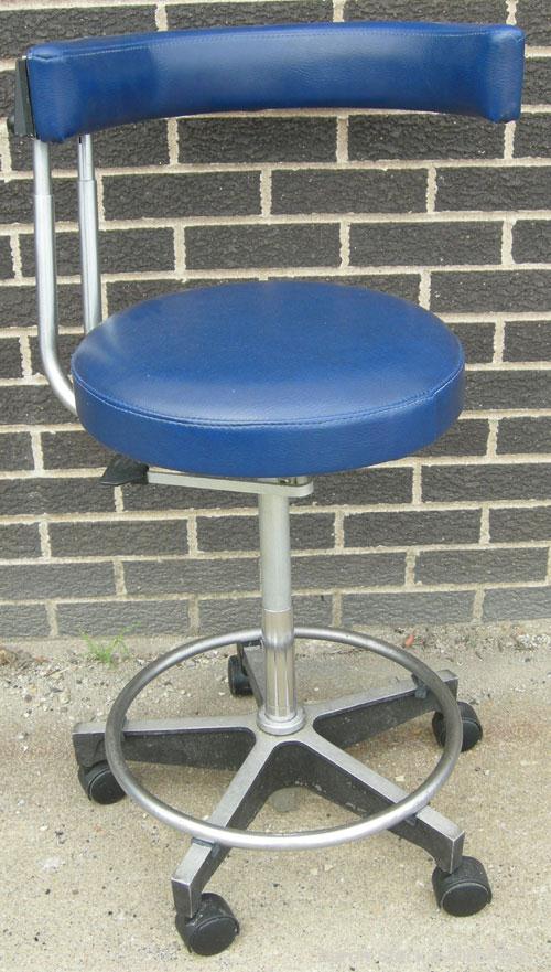 Used Dentsply blue assistant stool.  Mounted on casters.