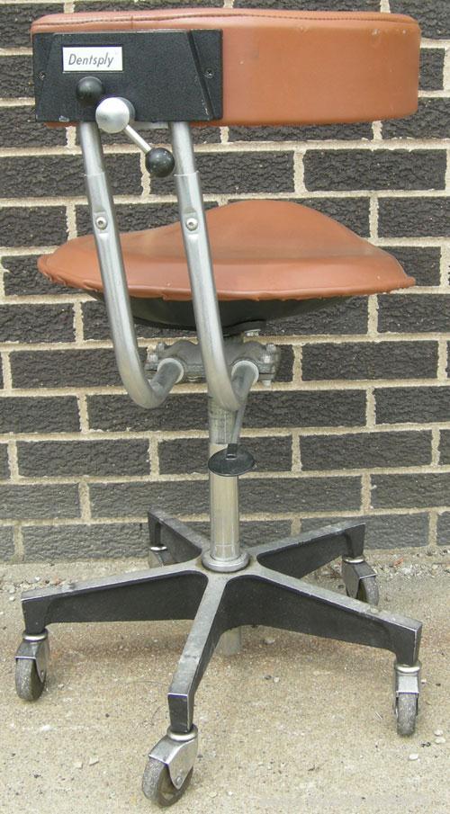 Used Dentsply tan assistant stool.  Mounted on casters.