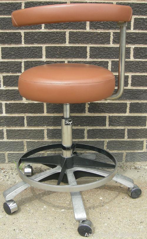 Used Dentsply tan assistant stool.  Mounted on casters.