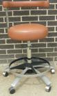 Used Dentsply tan assistant stool.  Mounted on casters.