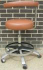 Used Dentsply tan assistant stool.  Mounted on casters.