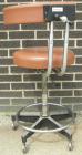 Used Dentsply tan assistant stool.  Mounted on casters.