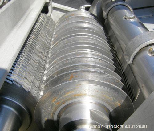 Used Urschel Dicer, Model M, 304 stainless steel. Designed for dicing or strip cutting food products. 11" wide x 60" long infeed conveyor, (1) feed roll, (17) 4 1/2" diameter circular knives, feed dr...