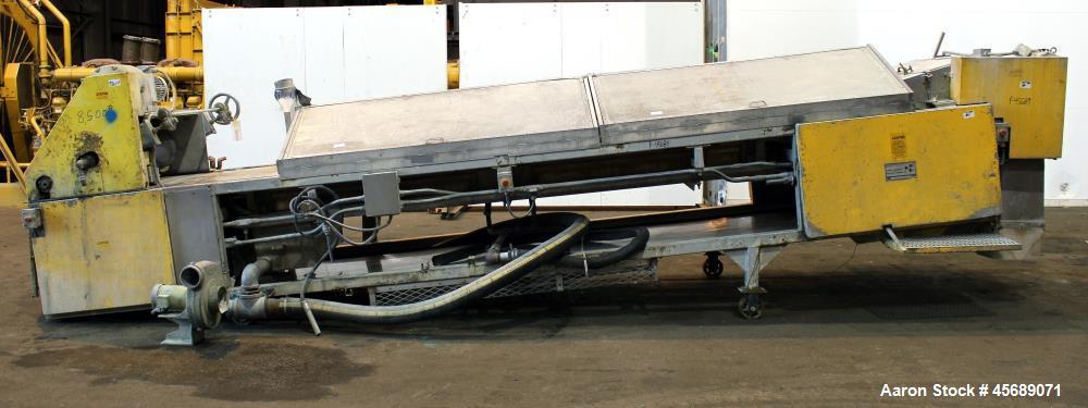 Used Buss Condux cooling belt. Approximate 39-3/8" wide x 210" long stainless steel belt, driven by a 2hp gear motor. (2) Approximate 40" wide x 12" diameter cored infeed rolls, driven by a 5hp motor.