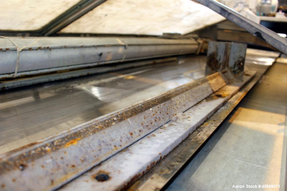 Used Buss Condux cooling belt. Approximate 39-3/8" wide x 210" long stainless steel belt, driven by a 2hp gear motor. (2) Approximate 40" wide x 12" diameter cored infeed rolls, driven by a 5hp motor.