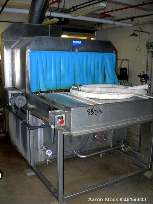 Used:  Ecolab continuous pan washer, model CD-906PW, stainless steel. Approx 51" wide x 15' long wash/dry area, 40" long infeed, 40" long outfeed table. Will wash 18" wide x 38" long x 2-1/2" deep pa...
