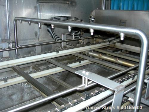 Used:  Ecolab continuous pan washer, model CD-906PW, stainless steel. Approx 51" wide x 15' long wash/dry area, 40" long infeed, 40" long outfeed table. Will wash 18" wide x 38" long x 2-1/2" deep pa...
