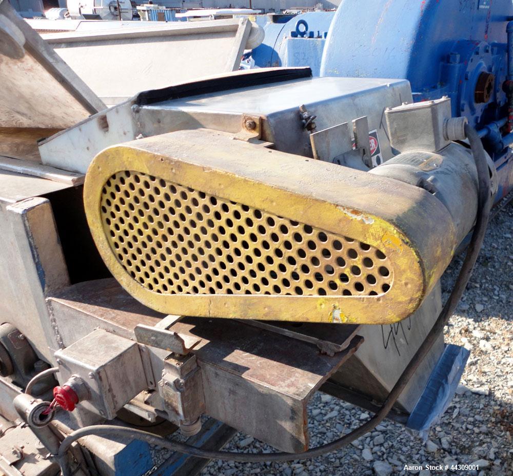 Used Spray Belt Cooler, 301 Stainless Steel. 19-1/2" Wide x 204" long belt. Driven by a 2 hp, 3/60/208-230/460 volt, 1725 rpm gear motor, ratio 10.0 to 1. (2) Cored feed roll assemblies, driven by an...