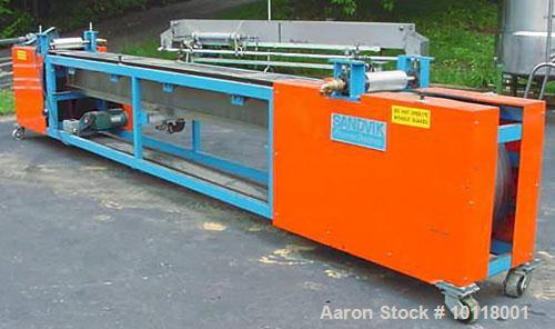 Used Sandvik Belt Cooler (Sandvik Process Systems) 12" x 16' long with polished stainless steel belt. Dual 12" wide x 4.5" diameter jacketed rolls are mounted above cooling belt at beginning and term...