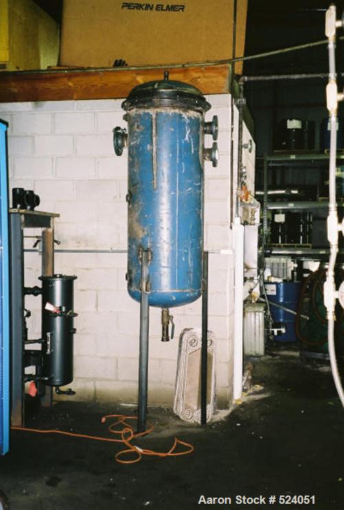 USED: Flash drying system designed to remove 1% to 2% water from industrial lubricating oils. Oil is pumped through a plate type heat exchanger where it enters the flash dryer chambers through a spra...
