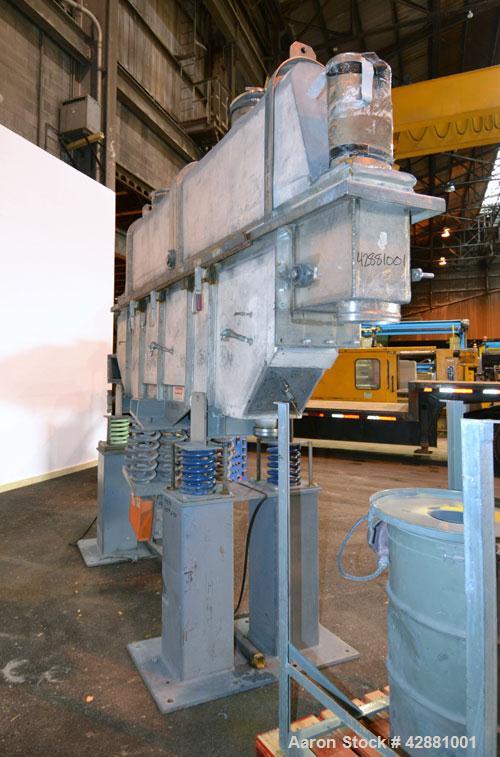 Used Carrier Vibrating Equipment Dryer/Cooler, Model FCAD-12100S, 304 Stainless Steel. 11’’ wide x 135’’ long trough, approximately 120’’ long section with a perforated “W” shaped deck. Top end feed,...