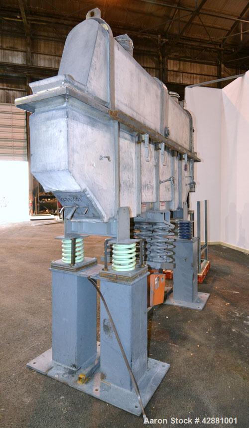 Used Carrier Vibrating Equipment Dryer/Cooler, Model FCAD-12100S, 304 Stainless Steel. 11’’ wide x 135’’ long trough, approximately 120’’ long section with a perforated “W” shaped deck. Top end feed,...
