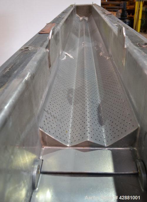 Used Carrier Vibrating Equipment Dryer/Cooler, Model FCAD-12100S, 304 Stainless Steel. 11’’ wide x 135’’ long trough, approximately 120’’ long section with a perforated “W” shaped deck. Top end feed,...