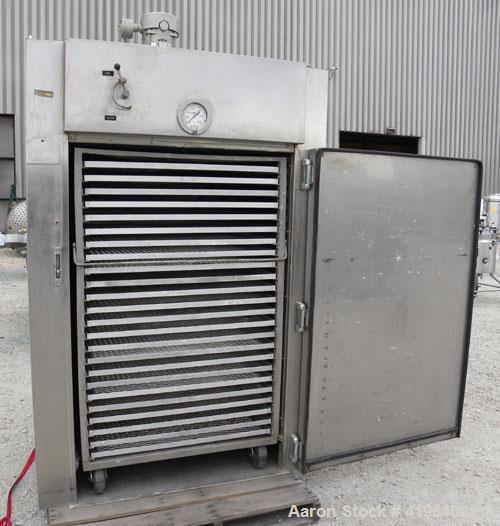 Used Stokes Drying Cabinet, Model 38-7, 304 stainless steel. Opening 40 wide x 63 tall x 30 deep. Includes a stainless steel roll out cart with (24) aluminum trays, 35 wide x 27 deep, spaced 1 apart....