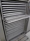 Used Stokes Drying Cabinet, Model 38-7, 304 stainless steel. Opening 40 wide x 63 tall x 30 deep. Includes a stainless steel roll out cart with (24) aluminum trays, 35 wide x 27 deep, spaced 1 apart....
