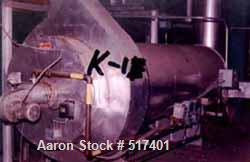USED: Indirect Heating Kiln, overall approximately 8' high x 6' wide x 40' long. Attached to it is a combustion unit 13' long X 3' diameter. Kiln has stainless steel flexible conveyor running full le...