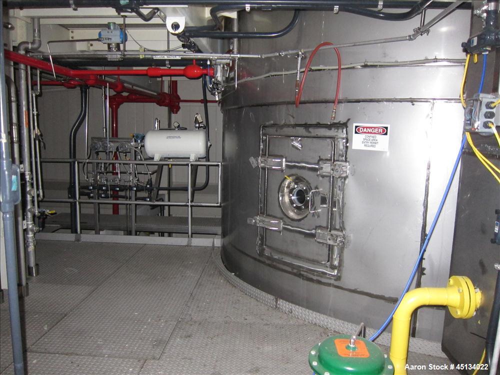 Used Niro Spray Tower Dryer. Originally designed for 12,500 pounds / hour of water evaporation. The dryer capacity was increased to 15,000 pounds / hour at 65,000 SCFM of air flow.  The Dryer is constructed of 316 L Stainless Steel. The dryer is a Standard Tall Form Dryer equipped with an integral static Fluid Bed Dryer and external Vibratory Fluid Bed Cooler. Both beds have heaters and the VFB also had a Cooler. The Dryer was equipped with fines return and agglomeration capabilities as an opti