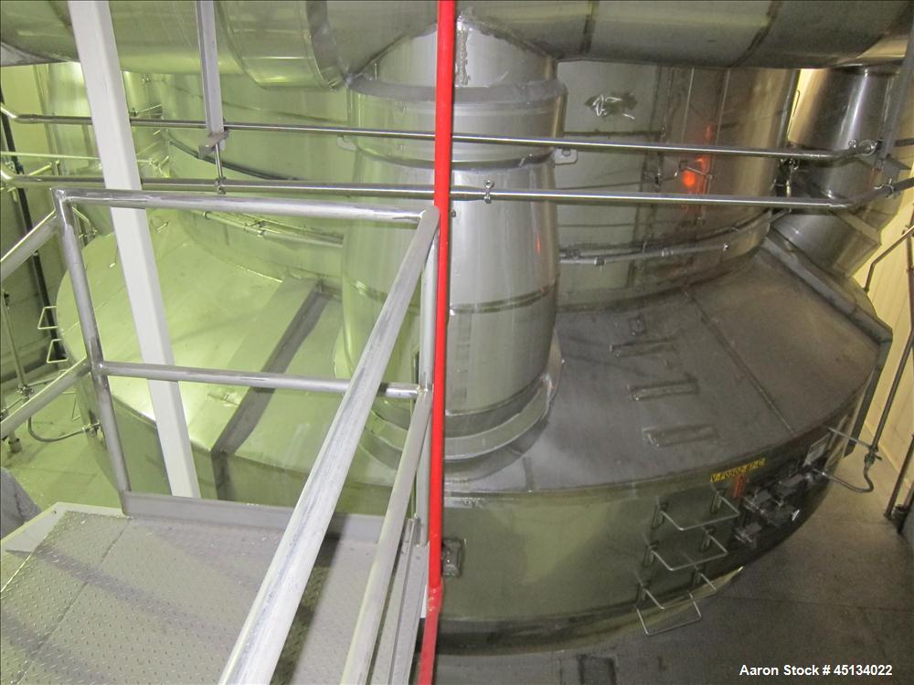 Used Niro Spray Tower Dryer. Originally designed for 12,500 pounds / hour of water evaporation. The dryer capacity was increased to 15,000 pounds / hour at 65,000 SCFM of air flow.  The Dryer is constructed of 316 L Stainless Steel. The dryer is a Standard Tall Form Dryer equipped with an integral static Fluid Bed Dryer and external Vibratory Fluid Bed Cooler. Both beds have heaters and the VFB also had a Cooler. The Dryer was equipped with fines return and agglomeration capabilities as an opti