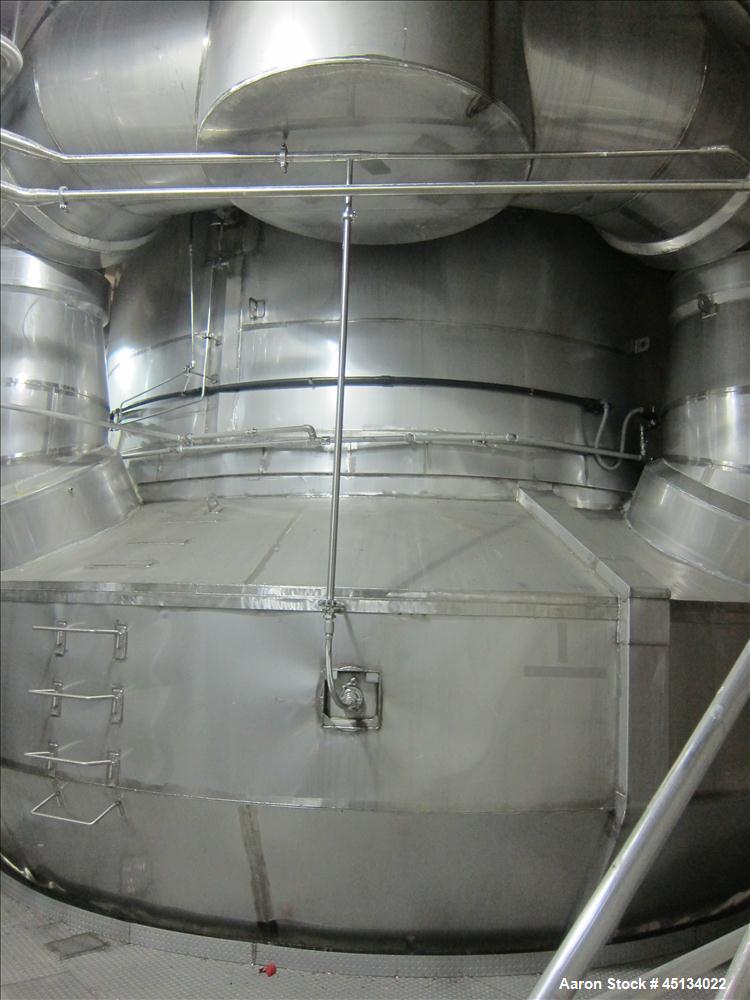 Used Niro Spray Tower Dryer. Originally designed for 12,500 pounds / hour of water evaporation. The dryer capacity was increased to 15,000 pounds / hour at 65,000 SCFM of air flow.  The Dryer is constructed of 316 L Stainless Steel. The dryer is a Standard Tall Form Dryer equipped with an integral static Fluid Bed Dryer and external Vibratory Fluid Bed Cooler. Both beds have heaters and the VFB also had a Cooler. The Dryer was equipped with fines return and agglomeration capabilities as an opti