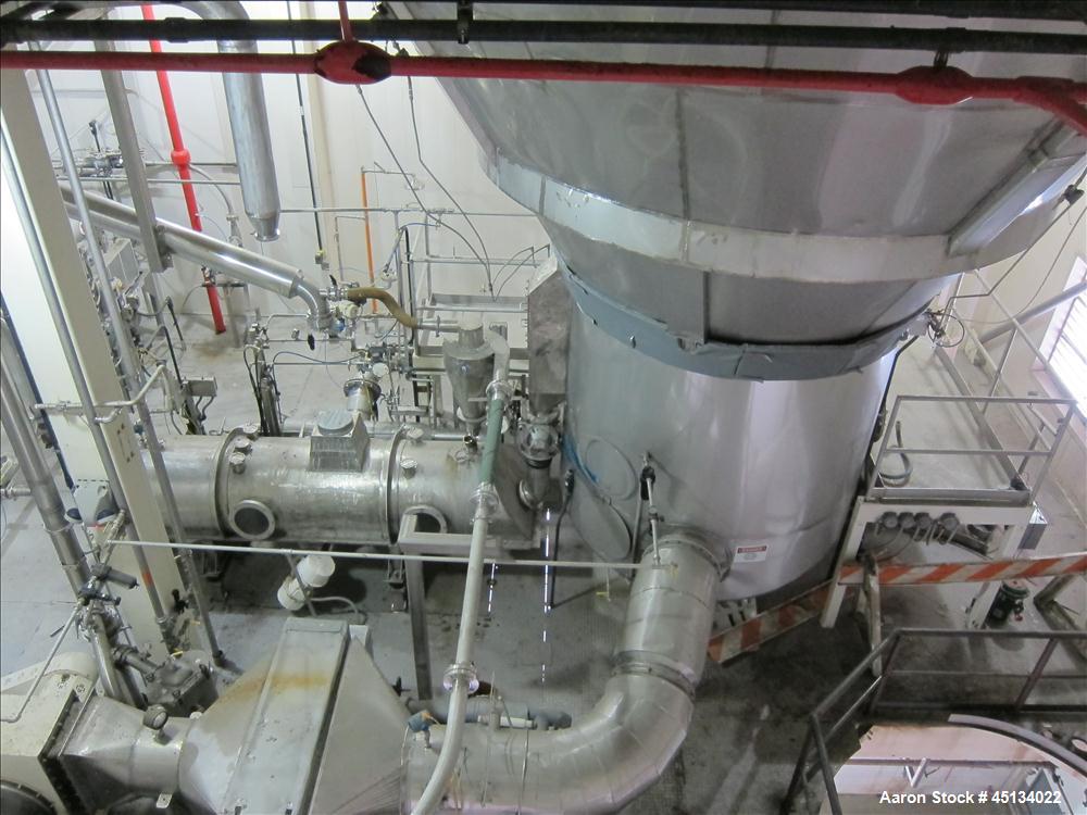 Used Niro Spray Tower Dryer. Originally designed for 12,500 pounds / hour of water evaporation. The dryer capacity was increased to 15,000 pounds / hour at 65,000 SCFM of air flow.  The Dryer is constructed of 316 L Stainless Steel. The dryer is a Standard Tall Form Dryer equipped with an integral static Fluid Bed Dryer and external Vibratory Fluid Bed Cooler. Both beds have heaters and the VFB also had a Cooler. The Dryer was equipped with fines return and agglomeration capabilities as an opti