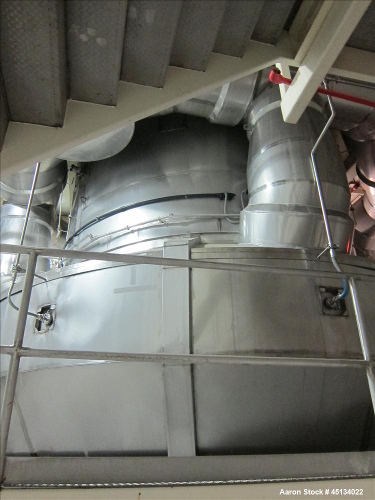 Used Niro Spray Tower Dryer. Originally designed for 12,500 pounds / hour of water evaporation. The dryer capacity was increased to 15,000 pounds / hour at 65,000 SCFM of air flow.  The Dryer is constructed of 316 L Stainless Steel. The dryer is a Standard Tall Form Dryer equipped with an integral static Fluid Bed Dryer and external Vibratory Fluid Bed Cooler. Both beds have heaters and the VFB also had a Cooler. The Dryer was equipped with fines return and agglomeration capabilities as an opti