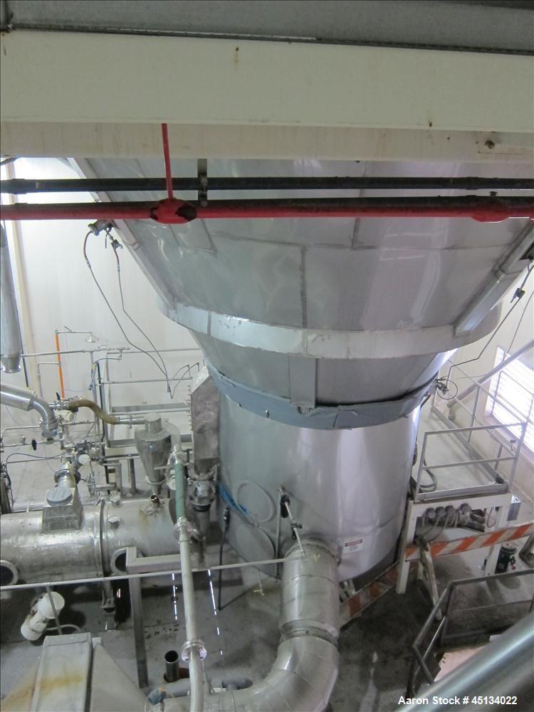 Used Niro Spray Tower Dryer. Originally designed for 12,500 pounds / hour of water evaporation. The dryer capacity was increased to 15,000 pounds / hour at 65,000 SCFM of air flow.  The Dryer is constructed of 316 L Stainless Steel. The dryer is a Standard Tall Form Dryer equipped with an integral static Fluid Bed Dryer and external Vibratory Fluid Bed Cooler. Both beds have heaters and the VFB also had a Cooler. The Dryer was equipped with fines return and agglomeration capabilities as an opti