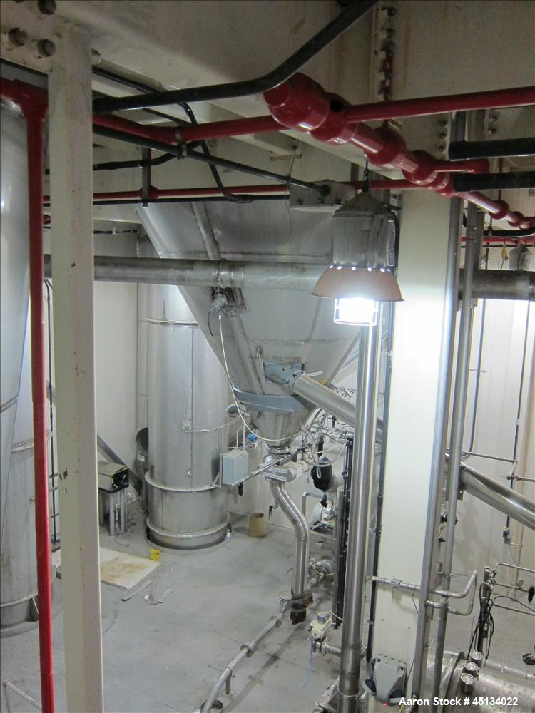 Used Niro Spray Tower Dryer. Originally designed for 12,500 pounds / hour of water evaporation. The dryer capacity was increased to 15,000 pounds / hour at 65,000 SCFM of air flow.  The Dryer is constructed of 316 L Stainless Steel. The dryer is a Standard Tall Form Dryer equipped with an integral static Fluid Bed Dryer and external Vibratory Fluid Bed Cooler. Both beds have heaters and the VFB also had a Cooler. The Dryer was equipped with fines return and agglomeration capabilities as an opti