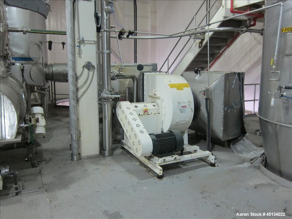 Used Niro Spray Tower Dryer. Originally designed for 12,500 pounds / hour of water evaporation. The dryer capacity was increased to 15,000 pounds / hour at 65,000 SCFM of air flow.  The Dryer is constructed of 316 L Stainless Steel. The dryer is a Standard Tall Form Dryer equipped with an integral static Fluid Bed Dryer and external Vibratory Fluid Bed Cooler. Both beds have heaters and the VFB also had a Cooler. The Dryer was equipped with fines return and agglomeration capabilities as an opti