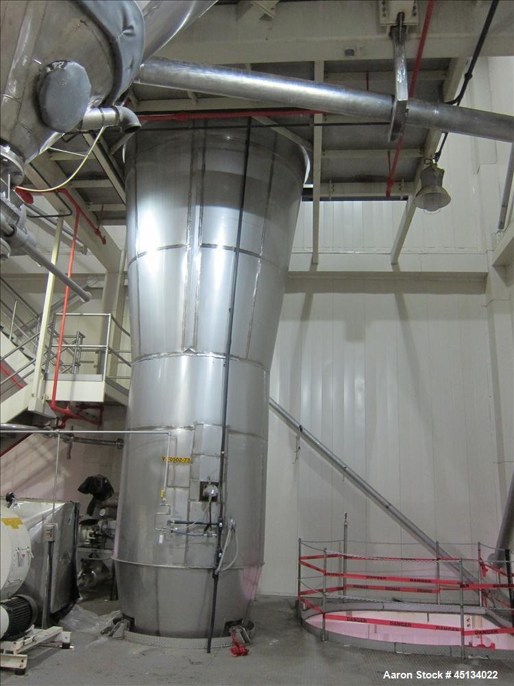 Used Niro Spray Tower Dryer. Originally designed for 12,500 pounds / hour of water evaporation. The dryer capacity was increased to 15,000 pounds / hour at 65,000 SCFM of air flow.  The Dryer is constructed of 316 L Stainless Steel. The dryer is a Standard Tall Form Dryer equipped with an integral static Fluid Bed Dryer and external Vibratory Fluid Bed Cooler. Both beds have heaters and the VFB also had a Cooler. The Dryer was equipped with fines return and agglomeration capabilities as an opti