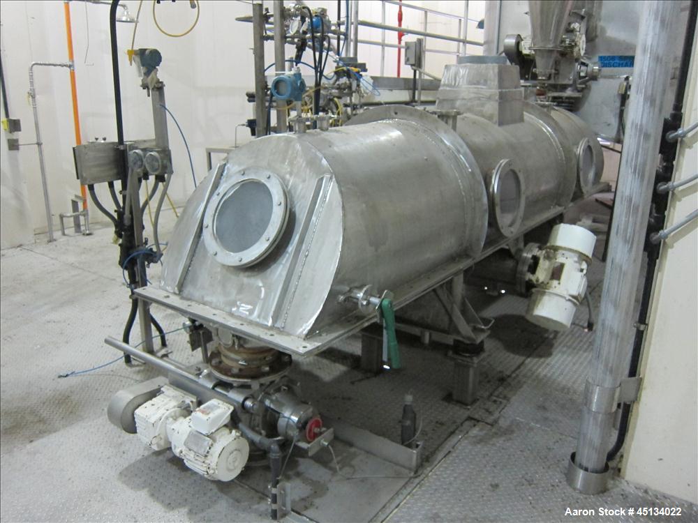 Used Niro Spray Tower Dryer. Originally designed for 12,500 pounds / hour of water evaporation. The dryer capacity was increased to 15,000 pounds / hour at 65,000 SCFM of air flow.  The Dryer is constructed of 316 L Stainless Steel. The dryer is a Standard Tall Form Dryer equipped with an integral static Fluid Bed Dryer and external Vibratory Fluid Bed Cooler. Both beds have heaters and the VFB also had a Cooler. The Dryer was equipped with fines return and agglomeration capabilities as an opti