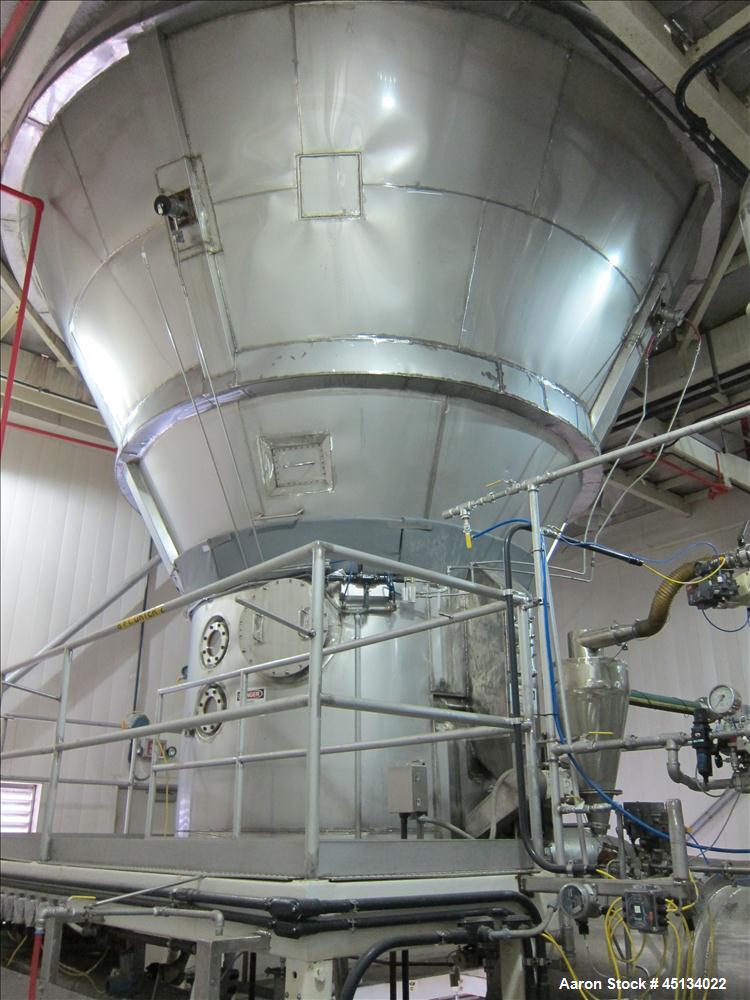 Used Niro Spray Tower Dryer. Originally designed for 12,500 pounds / hour of water evaporation. The dryer capacity was increased to 15,000 pounds / hour at 65,000 SCFM of air flow.  The Dryer is constructed of 316 L Stainless Steel. The dryer is a Standard Tall Form Dryer equipped with an integral static Fluid Bed Dryer and external Vibratory Fluid Bed Cooler. Both beds have heaters and the VFB also had a Cooler. The Dryer was equipped with fines return and agglomeration capabilities as an opti