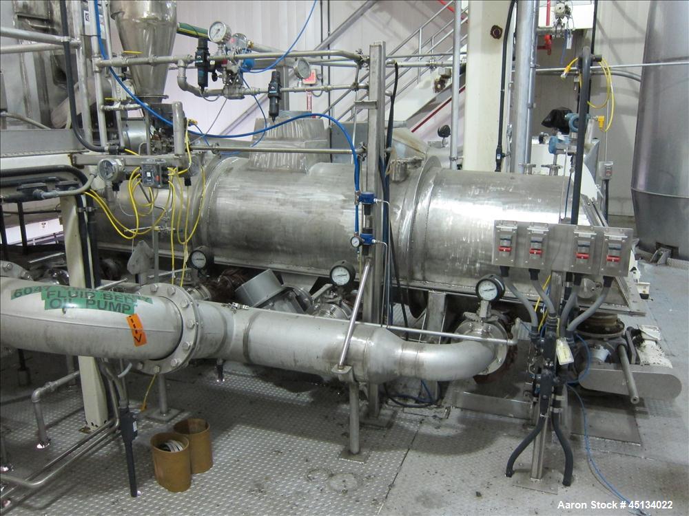 Used Niro Spray Tower Dryer. Originally designed for 12,500 pounds / hour of water evaporation. The dryer capacity was increased to 15,000 pounds / hour at 65,000 SCFM of air flow.  The Dryer is constructed of 316 L Stainless Steel. The dryer is a Standard Tall Form Dryer equipped with an integral static Fluid Bed Dryer and external Vibratory Fluid Bed Cooler. Both beds have heaters and the VFB also had a Cooler. The Dryer was equipped with fines return and agglomeration capabilities as an opti