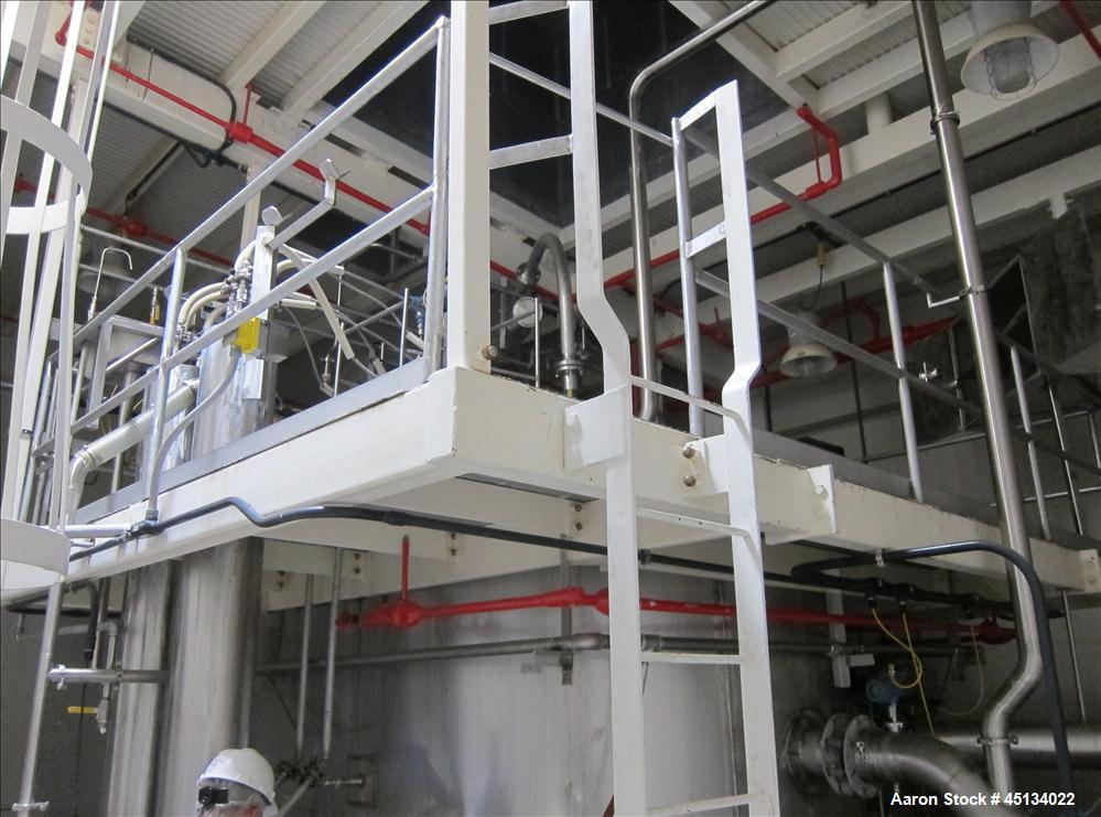 Used Niro Spray Tower Dryer. Originally designed for 12,500 pounds / hour of water evaporation. The dryer capacity was increased to 15,000 pounds / hour at 65,000 SCFM of air flow.  The Dryer is constructed of 316 L Stainless Steel. The dryer is a Standard Tall Form Dryer equipped with an integral static Fluid Bed Dryer and external Vibratory Fluid Bed Cooler. Both beds have heaters and the VFB also had a Cooler. The Dryer was equipped with fines return and agglomeration capabilities as an opti