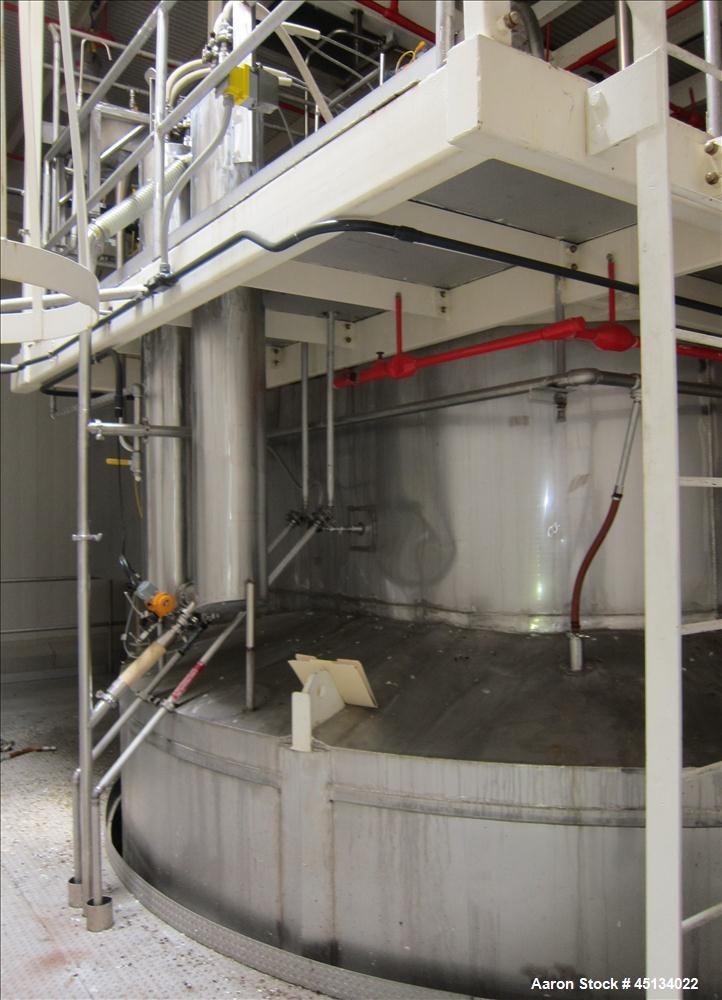 Used Niro Spray Tower Dryer. Originally designed for 12,500 pounds / hour of water evaporation. The dryer capacity was increased to 15,000 pounds / hour at 65,000 SCFM of air flow.  The Dryer is constructed of 316 L Stainless Steel. The dryer is a Standard Tall Form Dryer equipped with an integral static Fluid Bed Dryer and external Vibratory Fluid Bed Cooler. Both beds have heaters and the VFB also had a Cooler. The Dryer was equipped with fines return and agglomeration capabilities as an opti