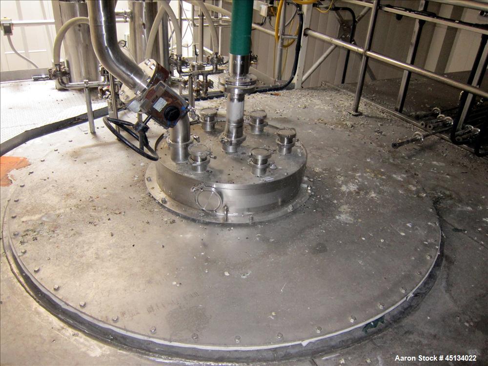 Used Niro Spray Tower Dryer. Originally designed for 12,500 pounds / hour of water evaporation. The dryer capacity was increased to 15,000 pounds / hour at 65,000 SCFM of air flow.  The Dryer is constructed of 316 L Stainless Steel. The dryer is a Standard Tall Form Dryer equipped with an integral static Fluid Bed Dryer and external Vibratory Fluid Bed Cooler. Both beds have heaters and the VFB also had a Cooler. The Dryer was equipped with fines return and agglomeration capabilities as an opti