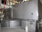 Used Niro Spray Tower Dryer. Originally designed for 12,500 pounds / hour of water evaporation. The dryer capacity was increased to 15,000 pounds / hour at 65,000 SCFM of air flow.  The Dryer is constructed of 316 L Stainless Steel. The dryer is a Standard Tall Form Dryer equipped with an integral static Fluid Bed Dryer and external Vibratory Fluid Bed Cooler. Both beds have heaters and the VFB also had a Cooler. The Dryer was equipped with fines return and agglomeration capabilities as an opti