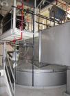 Used Niro Spray Tower Dryer. Originally designed for 12,500 pounds / hour of water evaporation. The dryer capacity was increased to 15,000 pounds / hour at 65,000 SCFM of air flow.  The Dryer is constructed of 316 L Stainless Steel. The dryer is a Standard Tall Form Dryer equipped with an integral static Fluid Bed Dryer and external Vibratory Fluid Bed Cooler. Both beds have heaters and the VFB also had a Cooler. The Dryer was equipped with fines return and agglomeration capabilities as an opti