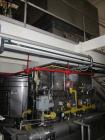 Used Niro Spray Tower Dryer. Originally designed for 12,500 pounds / hour of water evaporation. The dryer capacity was increased to 15,000 pounds / hour at 65,000 SCFM of air flow.  The Dryer is constructed of 316 L Stainless Steel. The dryer is a Standard Tall Form Dryer equipped with an integral static Fluid Bed Dryer and external Vibratory Fluid Bed Cooler. Both beds have heaters and the VFB also had a Cooler. The Dryer was equipped with fines return and agglomeration capabilities as an opti