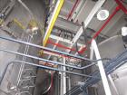 Used Niro Spray Tower Dryer. Originally designed for 12,500 pounds / hour of water evaporation. The dryer capacity was increased to 15,000 pounds / hour at 65,000 SCFM of air flow.  The Dryer is constructed of 316 L Stainless Steel. The dryer is a Standard Tall Form Dryer equipped with an integral static Fluid Bed Dryer and external Vibratory Fluid Bed Cooler. Both beds have heaters and the VFB also had a Cooler. The Dryer was equipped with fines return and agglomeration capabilities as an opti