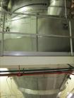 Used Niro Spray Tower Dryer. Originally designed for 12,500 pounds / hour of water evaporation. The dryer capacity was increased to 15,000 pounds / hour at 65,000 SCFM of air flow.  The Dryer is constructed of 316 L Stainless Steel. The dryer is a Standard Tall Form Dryer equipped with an integral static Fluid Bed Dryer and external Vibratory Fluid Bed Cooler. Both beds have heaters and the VFB also had a Cooler. The Dryer was equipped with fines return and agglomeration capabilities as an opti