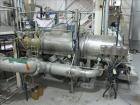 Used Niro Spray Tower Dryer. Originally designed for 12,500 pounds / hour of water evaporation. The dryer capacity was increased to 15,000 pounds / hour at 65,000 SCFM of air flow.  The Dryer is constructed of 316 L Stainless Steel. The dryer is a Standard Tall Form Dryer equipped with an integral static Fluid Bed Dryer and external Vibratory Fluid Bed Cooler. Both beds have heaters and the VFB also had a Cooler. The Dryer was equipped with fines return and agglomeration capabilities as an opti