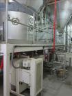 Used Niro Spray Tower Dryer. Originally designed for 12,500 pounds / hour of water evaporation. The dryer capacity was increased to 15,000 pounds / hour at 65,000 SCFM of air flow.  The Dryer is constructed of 316 L Stainless Steel. The dryer is a Standard Tall Form Dryer equipped with an integral static Fluid Bed Dryer and external Vibratory Fluid Bed Cooler. Both beds have heaters and the VFB also had a Cooler. The Dryer was equipped with fines return and agglomeration capabilities as an opti