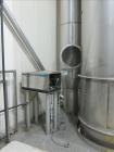 Used Niro Spray Tower Dryer. Originally designed for 12,500 pounds / hour of water evaporation. The dryer capacity was increased to 15,000 pounds / hour at 65,000 SCFM of air flow.  The Dryer is constructed of 316 L Stainless Steel. The dryer is a Standard Tall Form Dryer equipped with an integral static Fluid Bed Dryer and external Vibratory Fluid Bed Cooler. Both beds have heaters and the VFB also had a Cooler. The Dryer was equipped with fines return and agglomeration capabilities as an opti