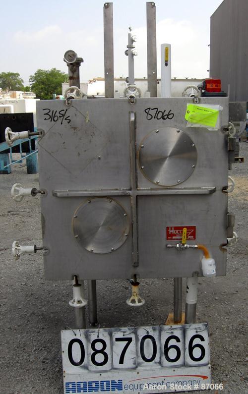 USED: Hull Corp vacuum shelf dryer, approximate 20 square feet. 316 stainless steel chamber 30" wide x 29" high x 41" deep, rated 25 psi at 350 deg F. (4) 24" wide x 36" deep x 1" thick jacketed 316 ...