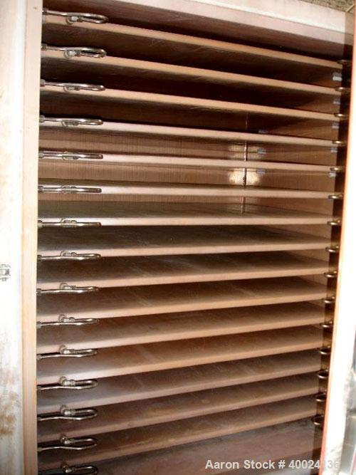 Used United McGill Vacuum Shelf Dryer. Model 11F.  Approximately 224.40 square feet. Chamber 60" wide x 69" tall x 47" deep. (15) 316 stainless steel shelves (14 usable) coated with "plasite" phenoli...